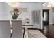 Sophisticated dining room featuring a glass table, elegant chandelier, and decorative paneling at 1250 Atherton Park, Roswell, GA 30076