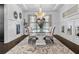 Chic dining room features wainscoting, a glass table, chandelier, and a decorative rug at 1250 Atherton Park, Roswell, GA 30076