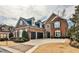 Beautiful brick two-story home with a manicured lawn and two-car garage, complete with black shutters and dark blue roof at 1250 Atherton Park, Roswell, GA 30076