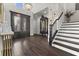 Stunning foyer featuring hardwood floors, high ceilings, elegant staircase, and decorative lighting at 1250 Atherton Park, Roswell, GA 30076