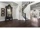 Elegant foyer features a staircase, dark wood floors, and decorative art, creating a grand entrance at 1250 Atherton Park, Roswell, GA 30076