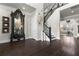 Elegant foyer features dark wood floors, staircase with black iron railings, and decorative wall art at 1250 Atherton Park, Roswell, GA 30076