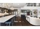 Open-concept kitchen with dark cabinets, stainless steel appliances, large island, and hardwood flooring at 1250 Atherton Park, Roswell, GA 30076