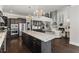 Bright kitchen featuring dark wood cabinets, granite countertops, a large island, and stainless steel appliances at 1250 Atherton Park, Roswell, GA 30076