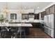 Bright kitchen with dark cabinets, stainless steel appliances, granite countertops, and a large center island with seating at 1250 Atherton Park, Roswell, GA 30076
