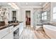 Luxurious primary bathroom with a soaking tub, glass shower, double vanity, and walk-in closet at 1250 Atherton Park, Roswell, GA 30076