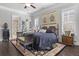 Well-lit main bedroom with hardwood floors, a decorative rug, and lots of natural light at 1250 Atherton Park, Roswell, GA 30076