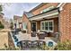 Charming brick home featuring an outdoor patio with ample seating and manicured landscaping at 1250 Atherton Park, Roswell, GA 30076