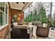 Covered patio with brickwork, lounge chairs around firepit, and colorful decorations at 1250 Atherton Park, Roswell, GA 30076