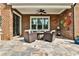 Inviting outdoor patio with brick surround, ceiling fan, and comfortable seating around a fire pit at 1250 Atherton Park, Roswell, GA 30076