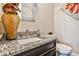Close-up on a powder room with granite countertop and decorative mirror at 1250 Atherton Park, Roswell, GA 30076