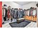 Well-organized walk-in closet with ample storage, a bench, and a plush rug at 1250 Atherton Park, Roswell, GA 30076