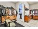 Spacious walk-in closet with bench, dresser, rods and shelves, with laundry room visible through doorway at 1250 Atherton Park, Roswell, GA 30076