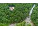 A lush, green forest surrounds this secluded property with a river flowing alongside, offering privacy at 3781 Anneewakee Rd, Douglasville, GA 30135