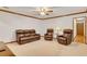 Finished basement recreation area with leather furniture and wet bar at 3781 Anneewakee Rd, Douglasville, GA 30135