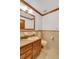 Clean bathroom with wood vanity and neutral tile at 3781 Anneewakee Rd, Douglasville, GA 30135