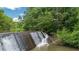 A dam highlights the waterfront living that this property offers in addition to providing calming scenery at 3781 Anneewakee Rd, Douglasville, GA 30135