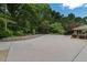 Large driveway offering ample parking space, complemented by well-maintained landscaping and greenery at 3781 Anneewakee Rd, Douglasville, GA 30135
