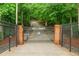 Private gated entrance displaying the property name with manicured landscaping to increase curb appeal at 3781 Anneewakee Rd, Douglasville, GA 30135