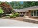 Beautiful brick home with manicured lawn, mature trees, and paved driveway at 3781 Anneewakee Rd, Douglasville, GA 30135
