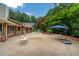 Spacious patio with outdoor seating area, brick trim, and lush landscaping at 3781 Anneewakee Rd, Douglasville, GA 30135