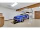 Garage with a car lift and a blue Mustang at 3781 Anneewakee Rd, Douglasville, GA 30135