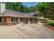 A spacious concrete patio is furnished with tables and chairs overlooking the meticulously landscaped yard at 3781 Anneewakee Rd, Douglasville, GA 30135