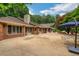 Enjoy outdoor living on the large patio with ample seating and a blue umbrella at 3781 Anneewakee Rd, Douglasville, GA 30135