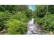 The gently flowing river next to a verdant, lush forest makes for an idyllic and serene property setting at 3781 Anneewakee Rd, Douglasville, GA 30135