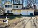 Two-story yellow house with a white garage and landscaped yard at 5615 Pennybrook Ct, Stone Mountain, GA 30087