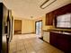 Kitchen with wood cabinets, tiled floor, and sliding glass door at 5615 Pennybrook Ct, Stone Mountain, GA 30087
