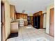 Galley kitchen with wood cabinets and tiled floors at 5615 Pennybrook Ct, Stone Mountain, GA 30087