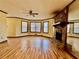 Living room with hardwood floors, stone fireplace, and lots of natural light at 5615 Pennybrook Ct, Stone Mountain, GA 30087