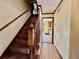 Staircase with wood railing leading to the second floor at 5615 Pennybrook Ct, Stone Mountain, GA 30087