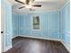 Light blue bedroom with wood-look floors and white trim at 106 Hillside Se Ave, Atlanta, GA 30315