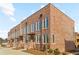 Side view of brick townhome community with landscaping at 137 Devore Rd, Alpharetta, GA 30009