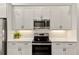 Modern kitchen with white cabinets and stainless steel appliances at 137 Devore Rd, Alpharetta, GA 30009