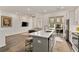 Open concept kitchen with island, stainless steel appliances, and hardwood floors at 137 Devore Rd, Alpharetta, GA 30009