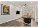 Open living room with hardwood floors, a sofa, and a large TV at 137 Devore Rd, Alpharetta, GA 30009
