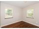 Well-lit bedroom with hardwood floors and two windows at 3141 Bellgreen Way, Decatur, GA 30032