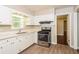 Updated kitchen with white cabinets, stainless steel appliances, and vinyl flooring at 3141 Bellgreen Way, Decatur, GA 30032