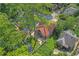 Stunning aerial view of a charming home with a red roof, lush green yard, and cozy backyard firepit area at 1290 Pasadena Ne Ave, Atlanta, GA 30306