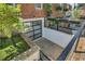 Backyard entrance with glass garage-style door, stone patio, and landscaping at 1290 Pasadena Ne Ave, Atlanta, GA 30306