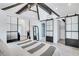 Stylish bedroom with a vaulted ceiling, exposed beams, barn doors, and modern decor at 1290 Pasadena Ne Ave, Atlanta, GA 30306