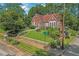 Beautiful brick home with lovely landscaping, a red roof, and a well-maintained lawn at 1290 Pasadena Ne Ave, Atlanta, GA 30306