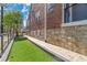 Charming brick home featuring an artificial turf side yard and stone foundation at 1290 Pasadena Ne Ave, Atlanta, GA 30306