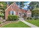 Charming brick home featuring a landscaped front yard, bay window, and inviting entrance at 1290 Pasadena Ne Ave, Atlanta, GA 30306