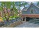 Side view of a brick house with a glass garage door and stone landscaping at 1290 Pasadena Ne Ave, Atlanta, GA 30306