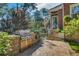 Outdoor grilling area featuring built-in grill, stone patio, and lush landscaping at 1290 Pasadena Ne Ave, Atlanta, GA 30306