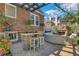 Backyard brick patio area including an outdoor kitchen, fireplace, and comfortable seating at 1290 Pasadena Ne Ave, Atlanta, GA 30306